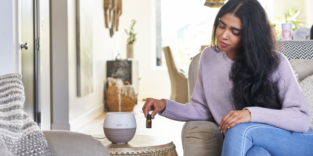 Woman trying aromatherapy scents in her living space.